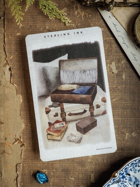 Single scene sticker featuring a sepia illustration of stacked, vintage brown suitcases and travel trunks, ideal for scrapbooking or journaling.
