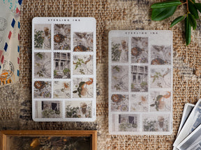 Collection of August-themed sticker sheets featuring vintage postage designs of detailed gardens, charming architecture, and rustic natural scenes.