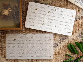 Elegant set of planner stickers featuring decorative, hand-lettered script labels for weekdays in August 2023.