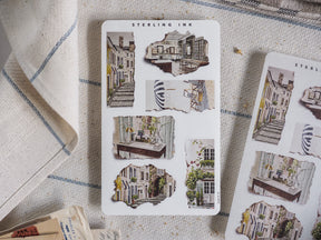 Torn paper sticker set featuring whimsical, sepia-toned sketches of historic European architecture, Parisian streets, and charming city scenes.