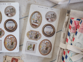 An assortment of vintage "Sterling Ink" picture frame stickers featuring nostalgic architectural scenes of Parisian and European street life.