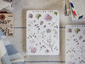 Watercolor sticker sheet featuring delicate botanical elements, including soft pink roses, trailing wildflowers, and various muted green leaves for themed journaling.