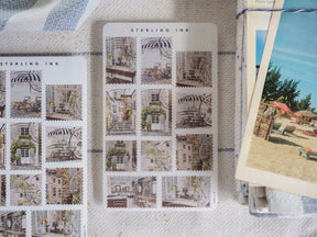 A detailed sticker sheet featuring a grid of vintage illustrations of quaint European street scenes, showcasing charming architecture, storefronts, and awnings.
