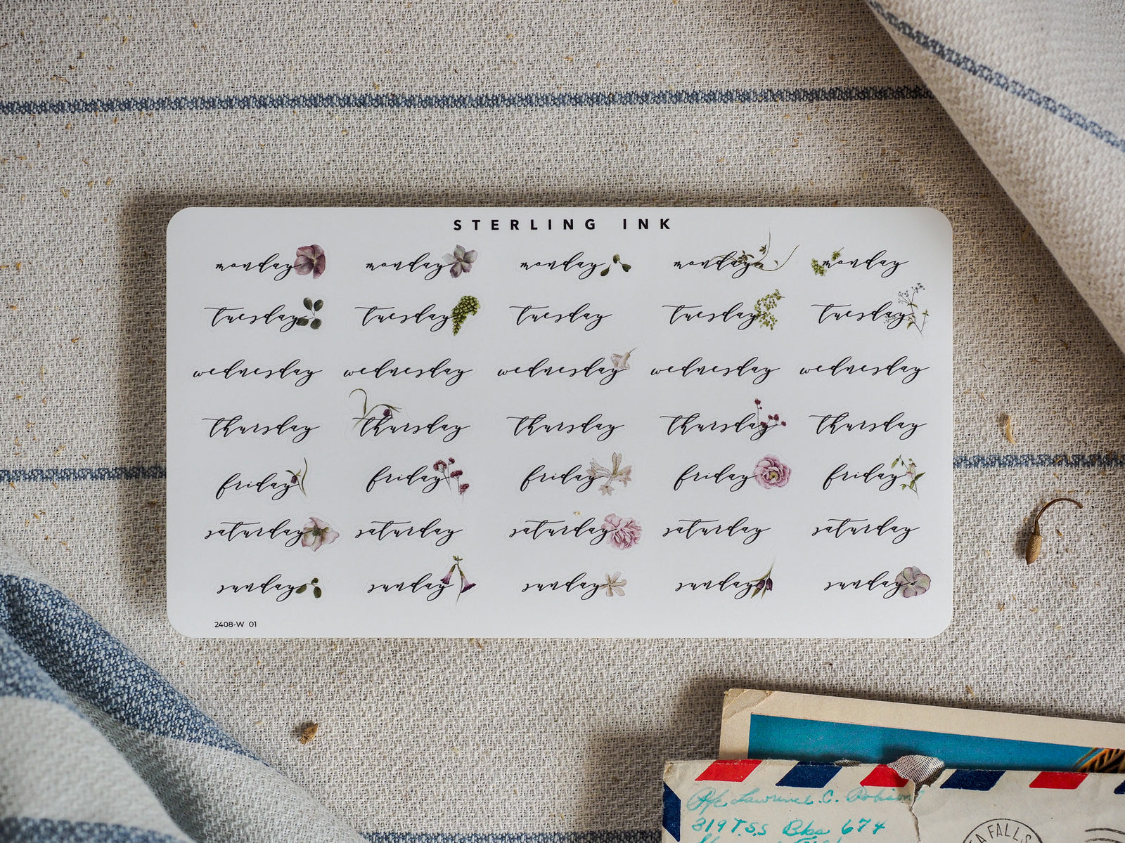 Planner sticker sheet for August 2024, featuring stylized typography for each weekday decorated with delicate watercolor floral and leaf accents.