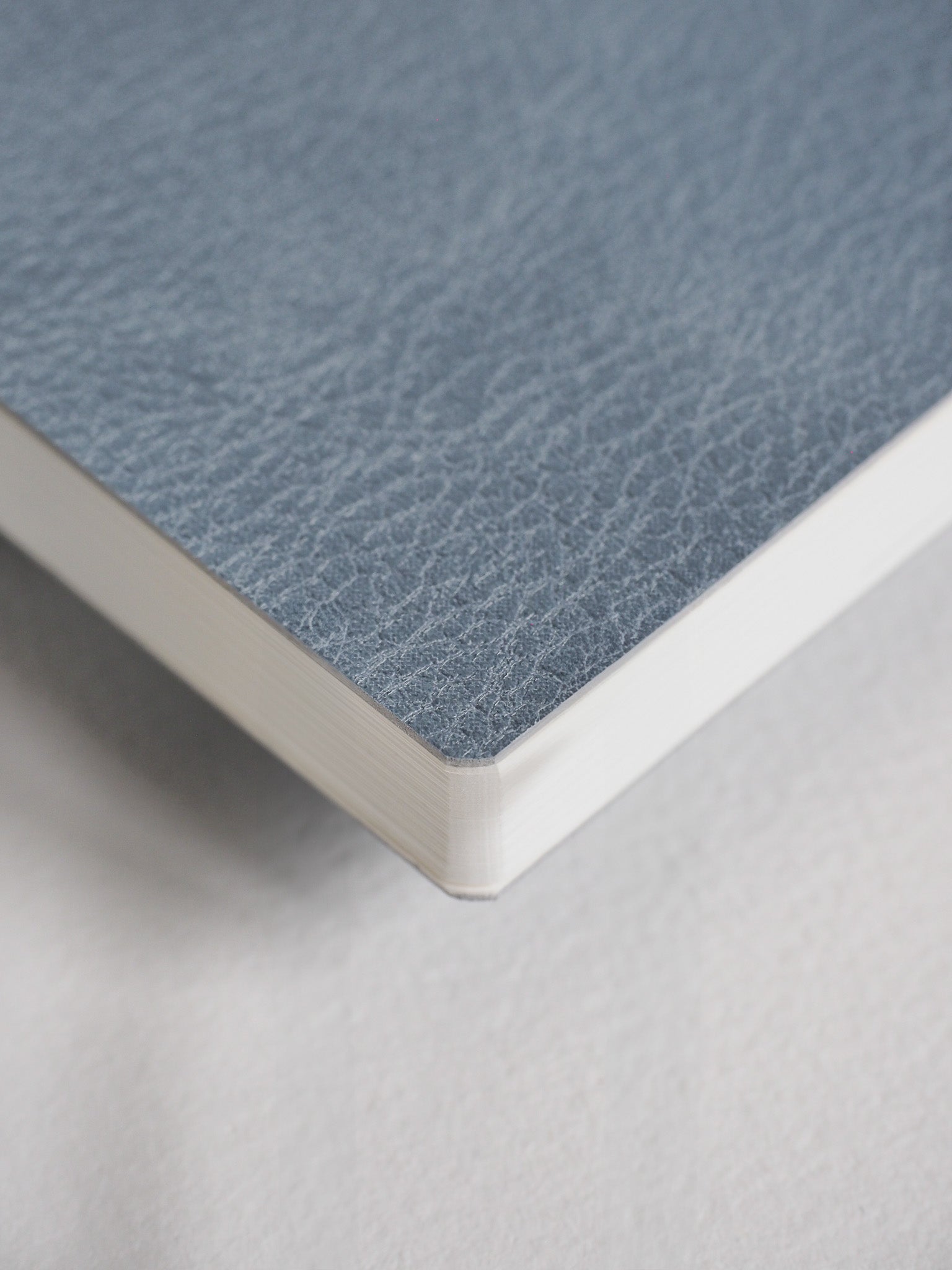 Matte charcoal gray grid notebook with a subtle textured cover, designed for organized note-taking and academic planning.