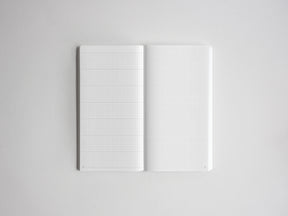 Open notebook featuring two pages of light gray graph paper, ideal for drafting, drawing, charting, or technical note-taking.