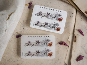 Rustic September month sticker featuring autumnal botanicals, sepia-toned illustrations of dried flowers, and elegant "Sterling Ink" script.