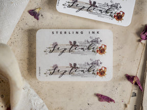 Elegant September month sticker featuring vintage botanical illustrations and flowing script text on rustic white cardstock.