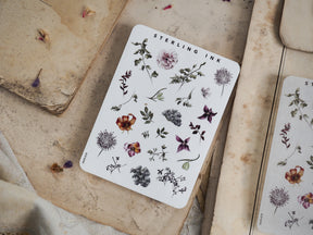 Detailed sticker sheet featuring intricate botanical elements, including various illustrated flowers and leaves in natural watercolor tones.