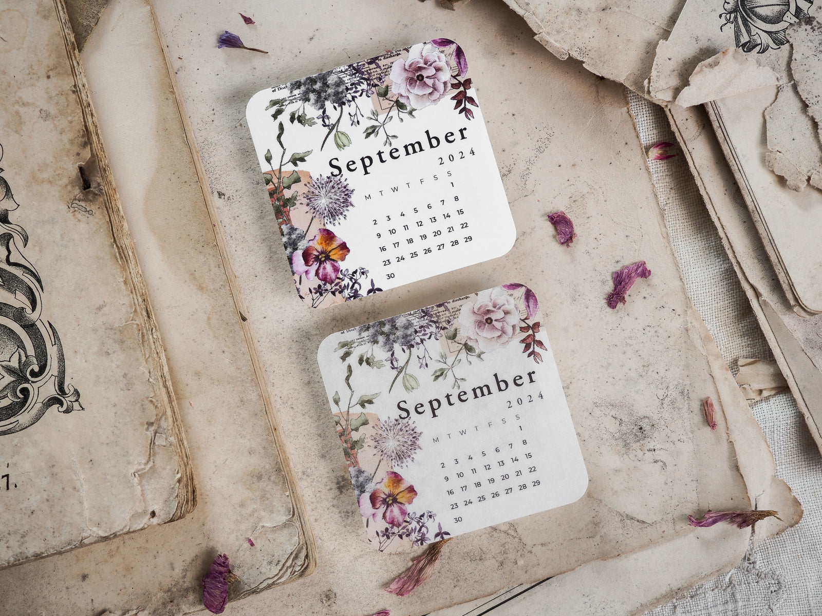 Decorative September 2024 monthly calendar featuring a romantic floral wreath border in muted shades of lilac, blush pink, and deep green.