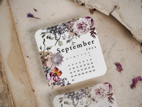 Vintage September 2024 monthly calendar featuring an elegant botanical arrangement of soft pink and purple blossoms, perfect for decorative scrapbooking or journaling.