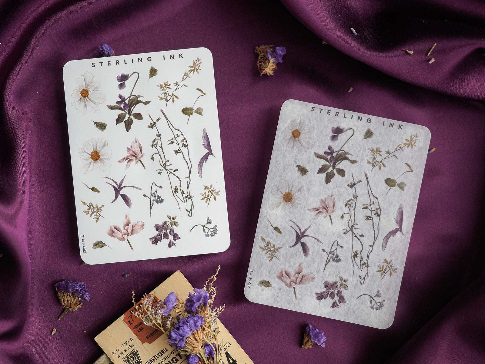 Pale botanical sheets featuring detailed ink illustrations of purple flowers, leaves, and assorted natural sketches labeled 'Sterling Ink.'