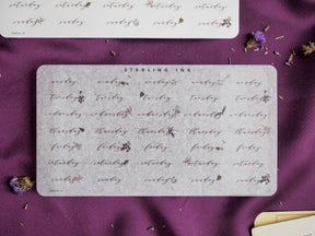 Decorative sticker sheets featuring flowing, elegant calligraphy of weekdays and dates for September 2023 printed on creamy off-white paper.