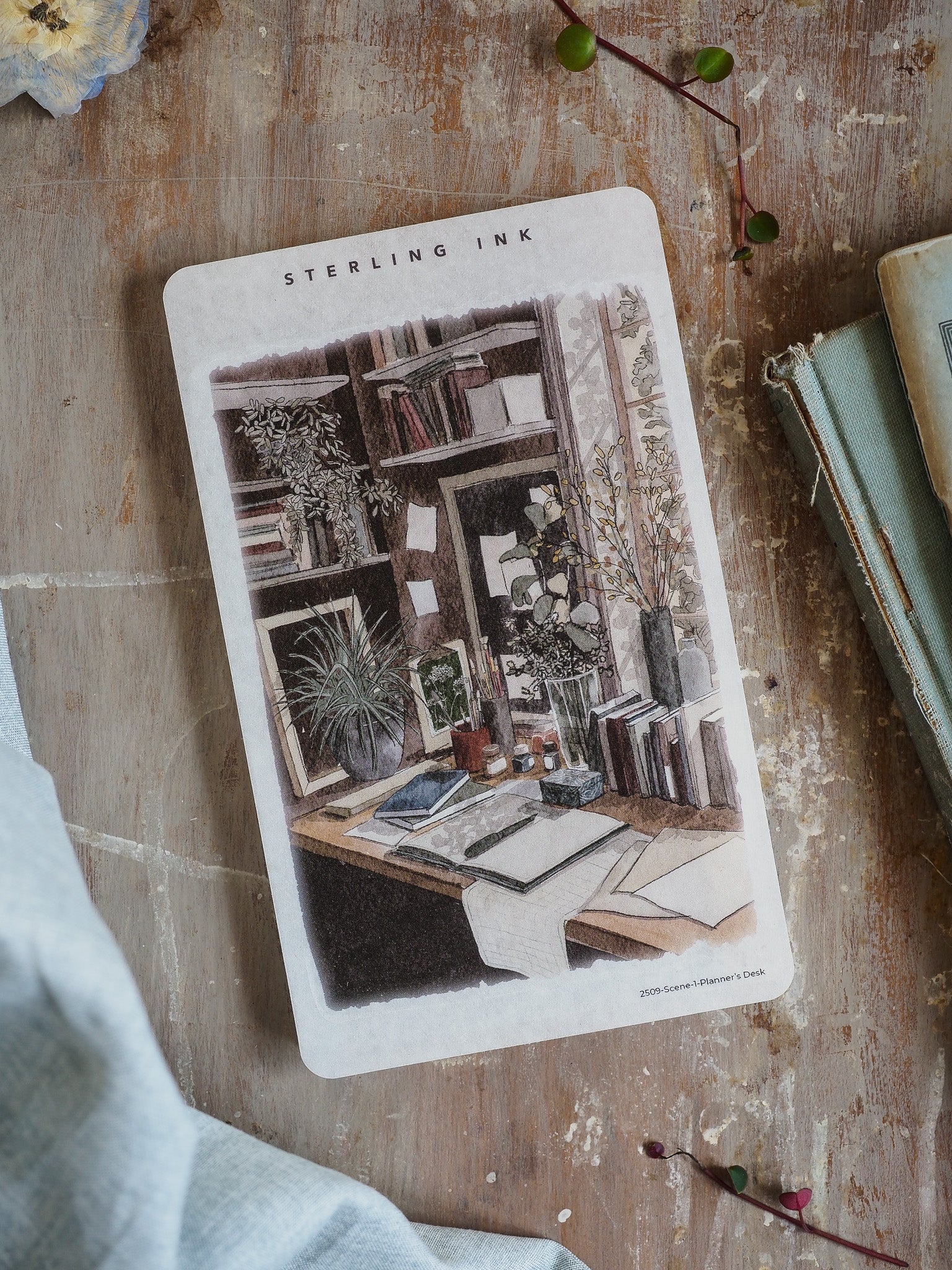Detailed illustration sticker of a cozy, academic planner's desk, featuring lush potted plants, stacked books, and warm decorative office supplies.