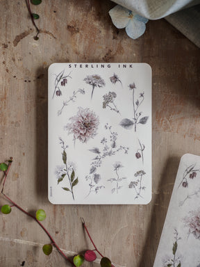 Botanical sticker sheet featuring various black ink hand-drawn illustrations of assorted wildflowers, leaves, and floral elements for journaling and scrapbooking.