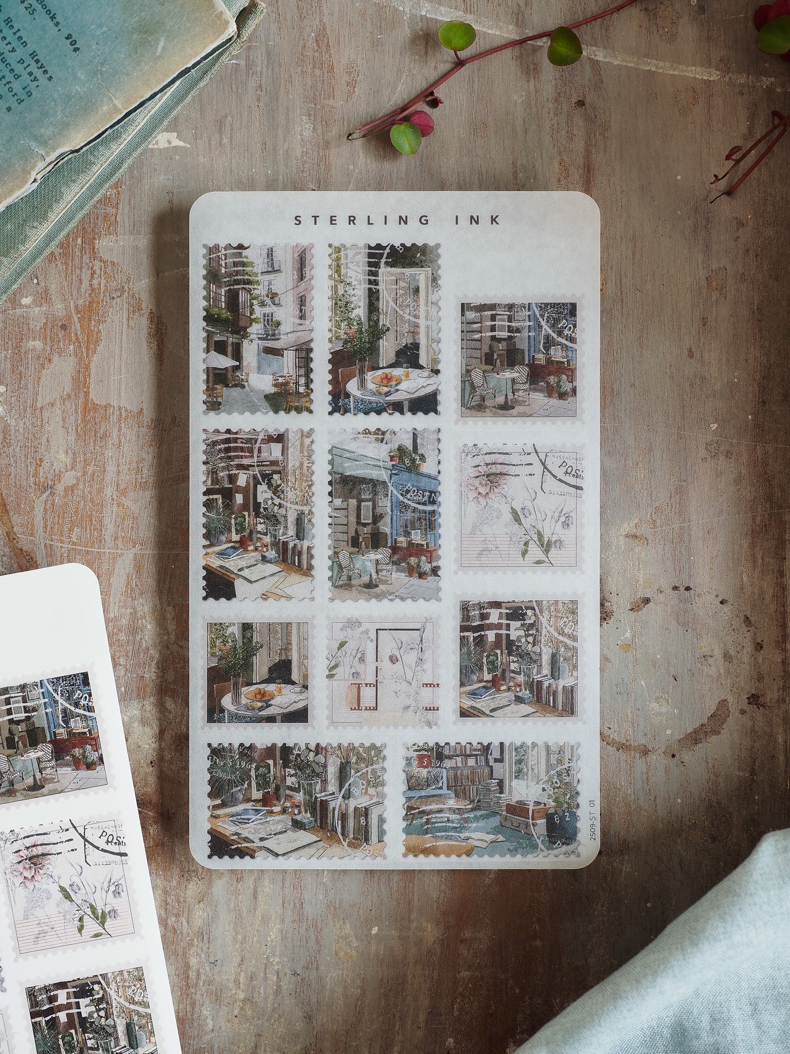 Vintage sticker sheet titled 'Sterling Ink' features a grid of sepia-toned illustrations depicting charming urban street scenes and historic architecture.