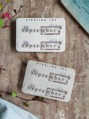 Vintage September planner stickers featuring the month's name and delicate watercolor grass illustrations framed by a rustic, distressed border design.