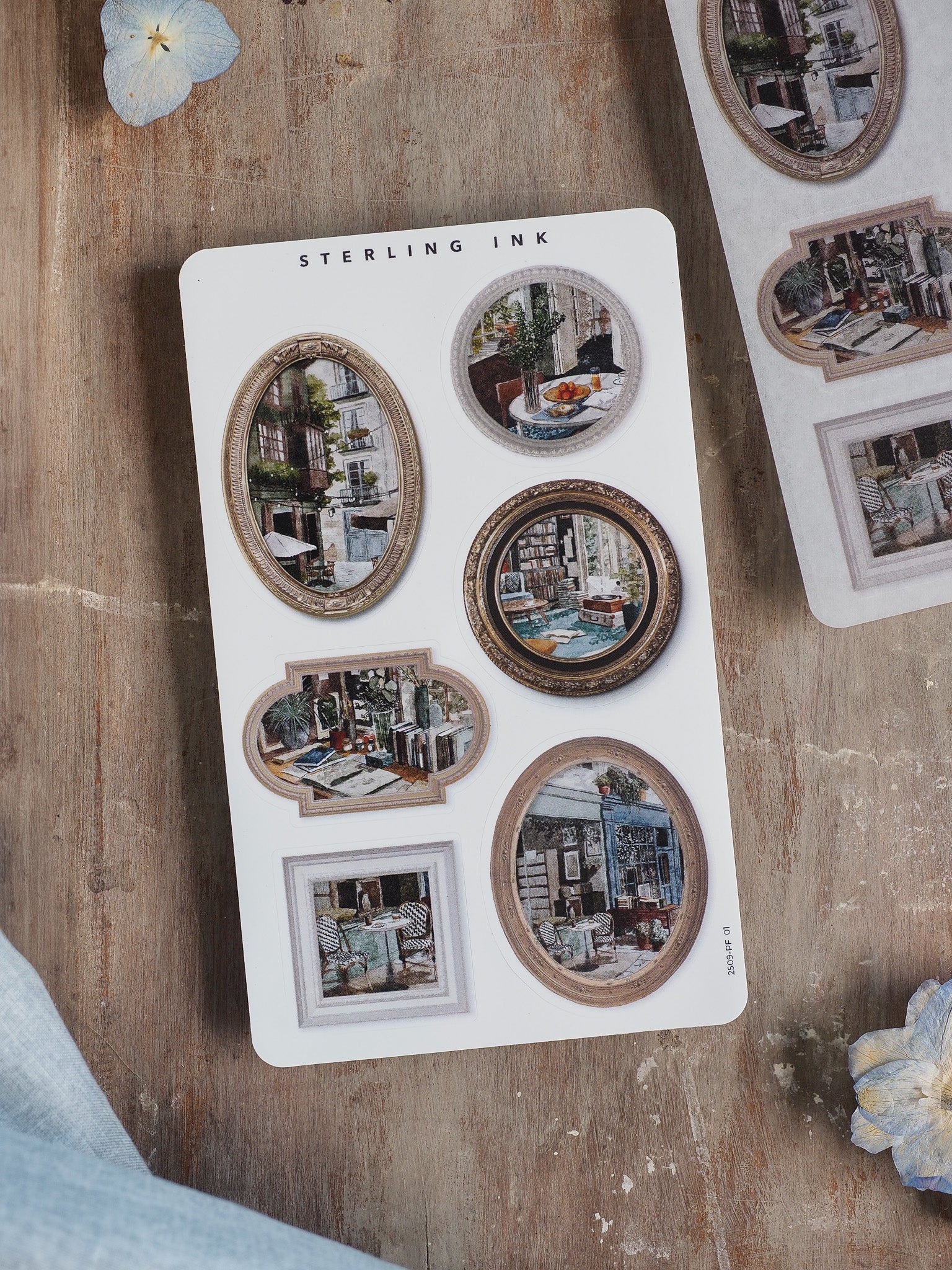 Ornate sticker sheet featuring various picture frame designs with vintage, detailed architectural stickers of charming European street scenes.