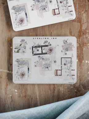 Elegant sticker sheet featuring antique botanical illustrations, corner accents, and labeled decorative strips with delicate silver foil accents.