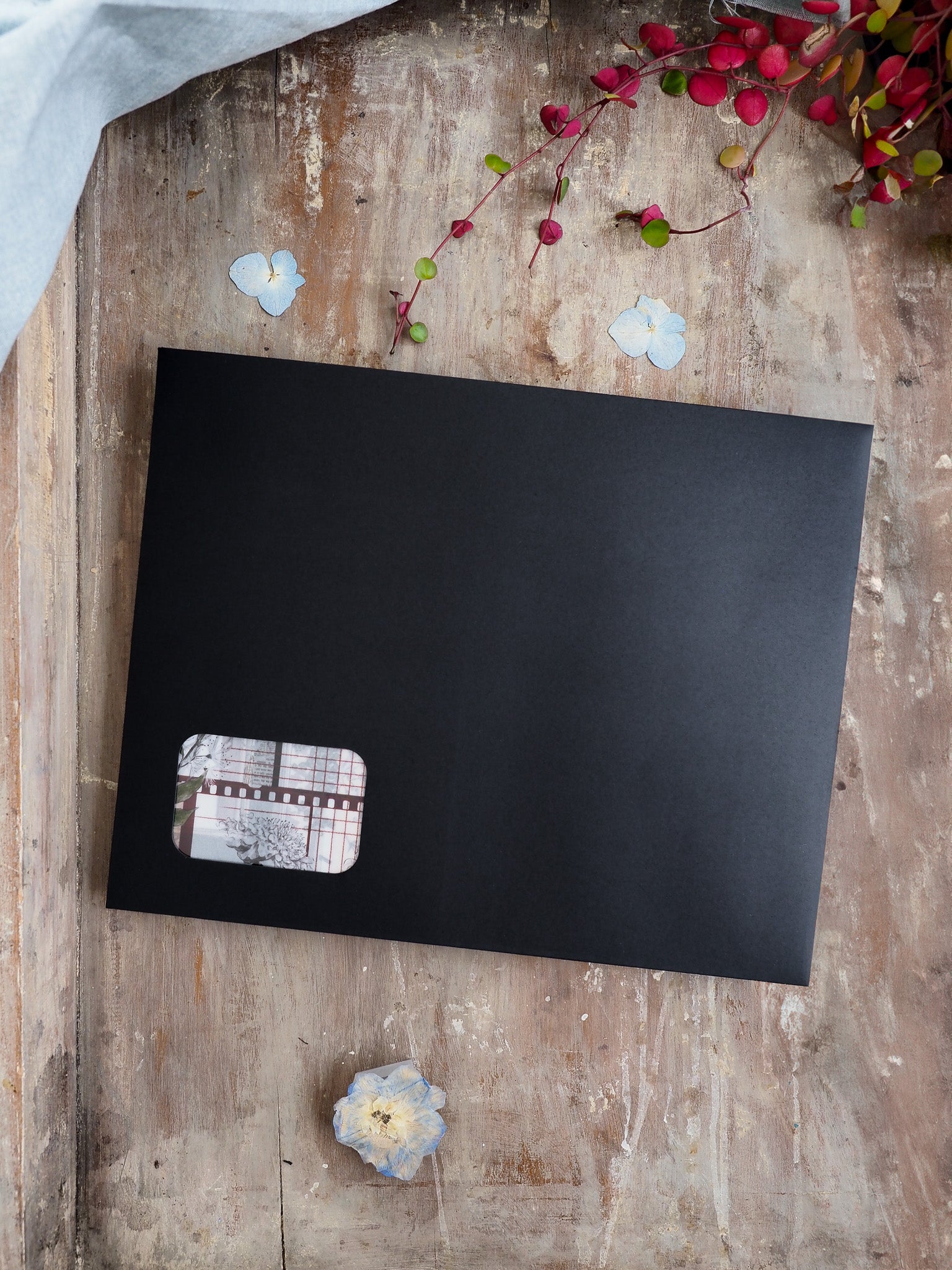 Sleek black journal or planner cover featuring a small, detailed patterned accent patch for a seasonal subscription kit.