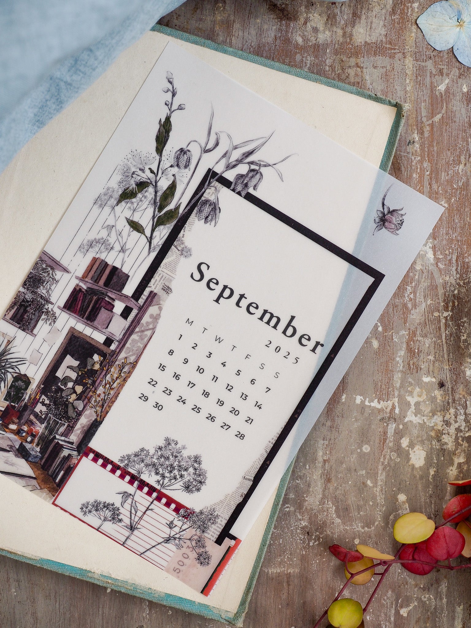 Elegant September 2025 monthly calendar featuring delicate botanical watercolor illustrations of lilies and a rustic architectural border.