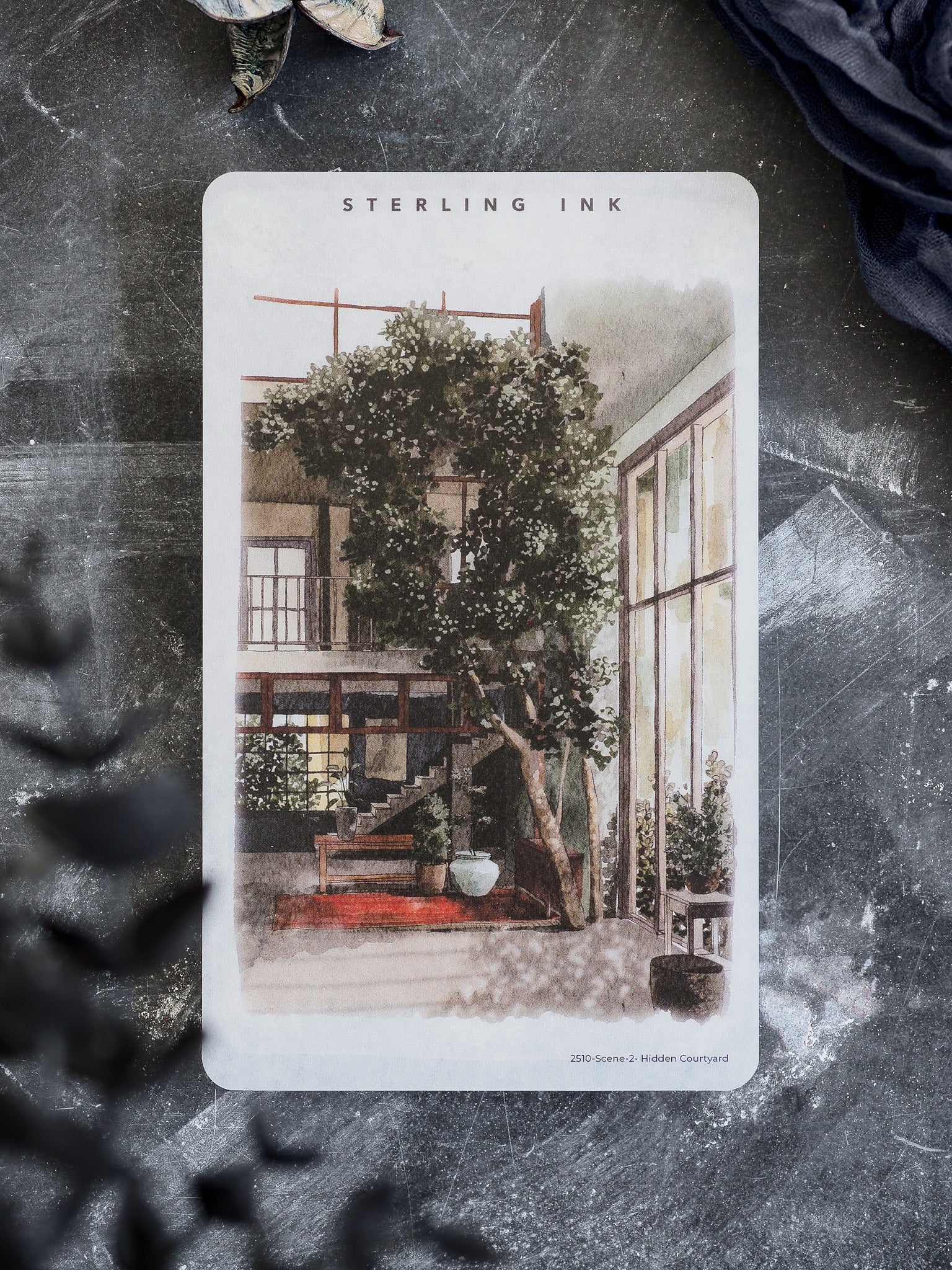 Watercolor illustration sticker titled 'Hidden Courtyard', depicting a lush, enclosed courtyard scene featuring a large central tree and warm architectural details.