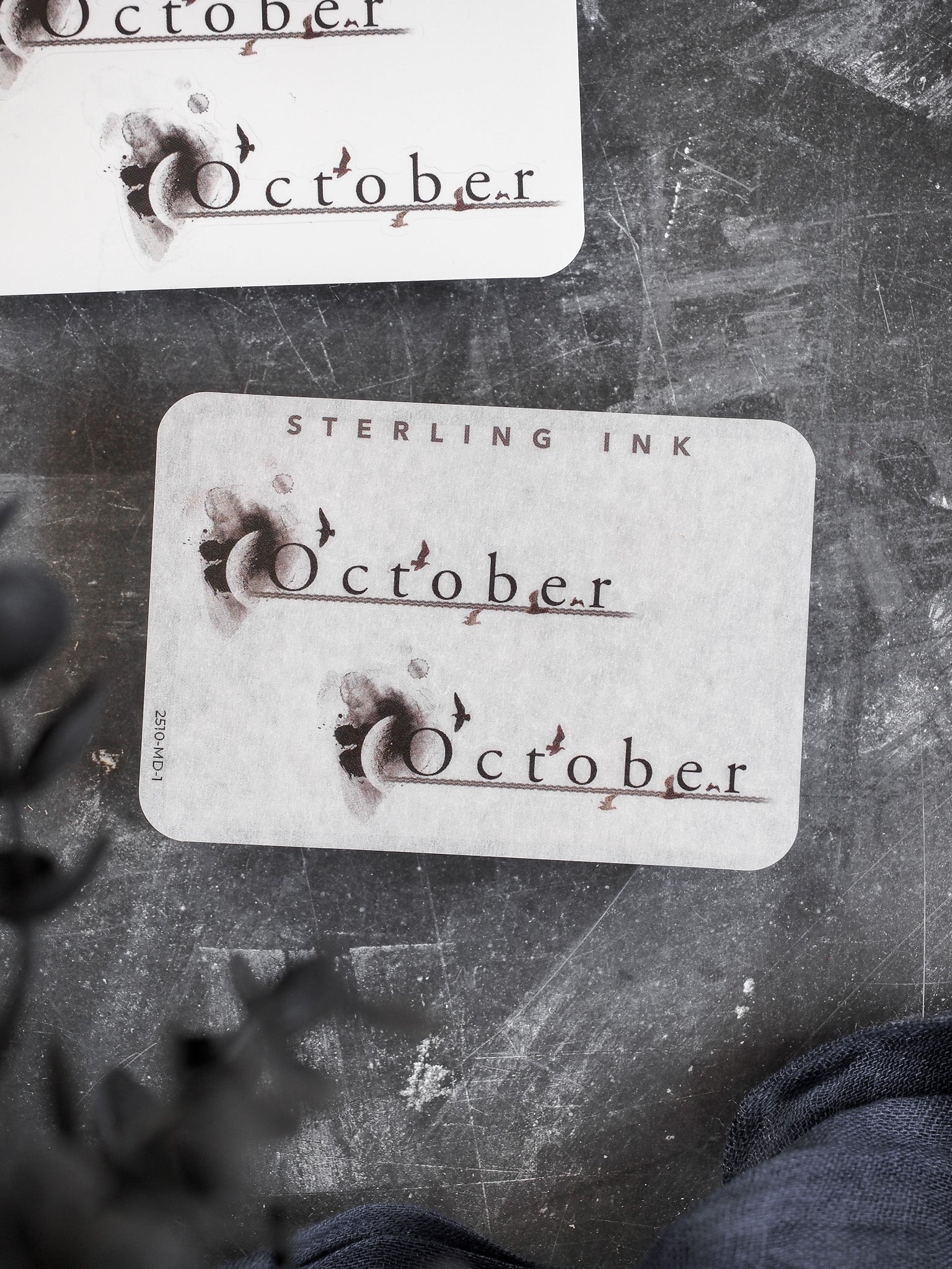 Rustic October month stickers featuring deep brown, distressed ink lettering and the "Sterling Ink" brand name for seasonal journaling and planning.