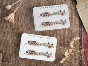 Decorative "October" month sticker labels featuring rustic, earthy botanicals, dried fall flowers, and seasonal accents perfect for journaling and planners.