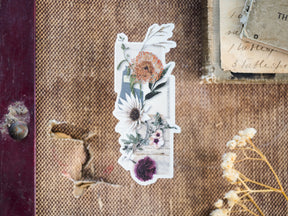 October-themed die-cut vinyl sticker featuring a rich autumn arrangement of dried white, cream, and burnt orange botanical flowers.