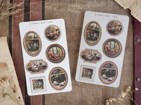 Decorative scrapbook stickers featuring assorted vintage brown frames filled with cozy, autumnal indoor scenes.