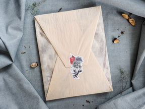 Intricate seasonal die-cut design featuring botanical black line art of autumn foliage, berries, and fall natural elements.