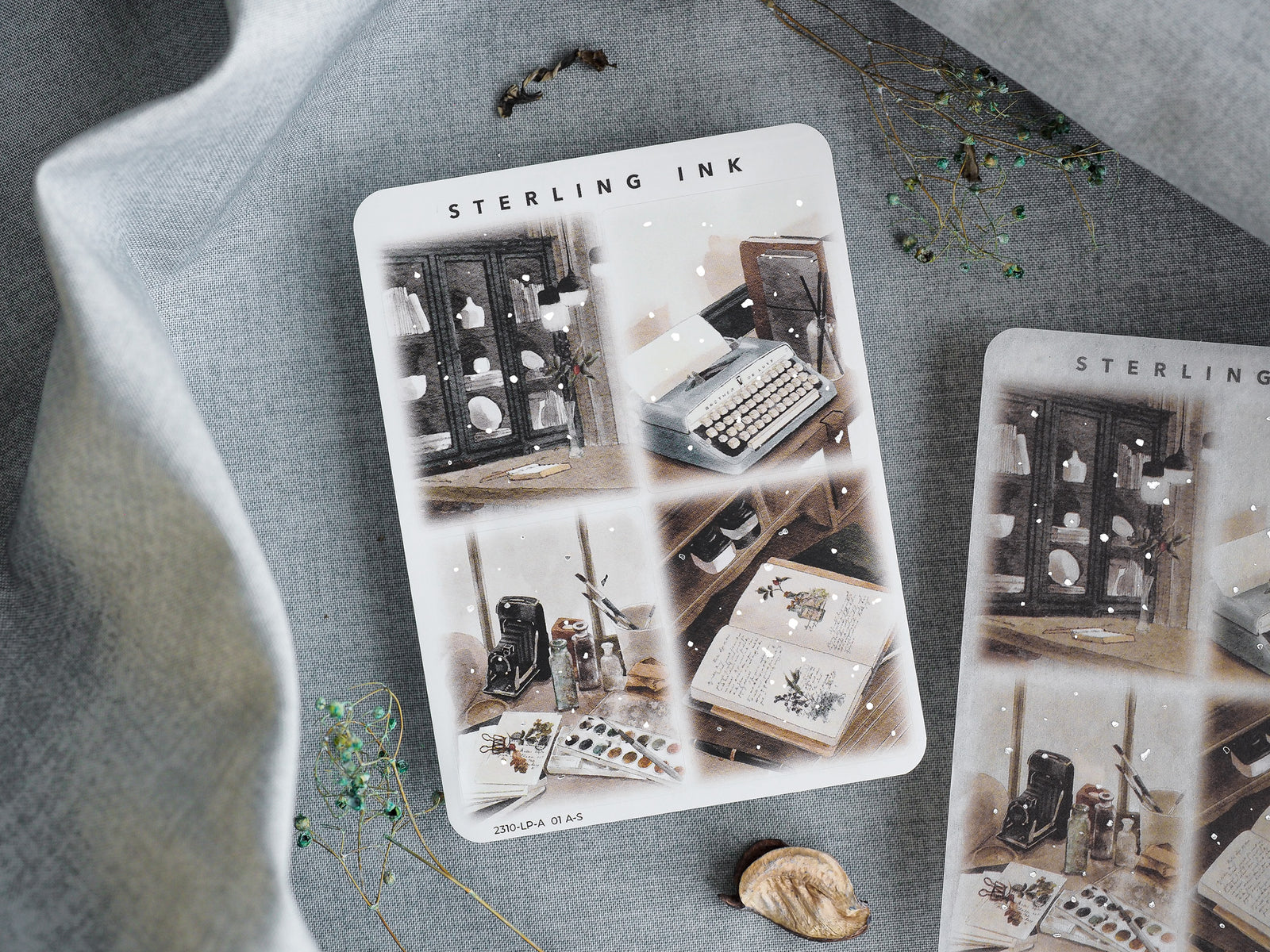 Large illustration sticker sheet featuring vintage, moody silver foil designs of antique objects, bookcases, and autumnal still life elements for October 2023 planning.