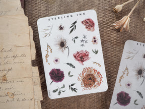Botanical sticker sheet titled "STERLING INK," showcasing autumnal elements like deep red roses, assorted seasonal daisies, leaves, and rustic floral sprigs for crafting.