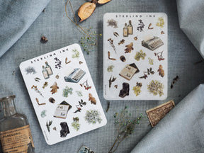 Sticker sheets featuring a fall-themed collection of vintage icons, including botanical elements, antique typewriters, and apothecary bottles.