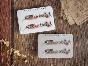 Autumn-themed October month stickers featuring the word "October" and rustic dried floral accents in muted earthy tones for planners and journals.