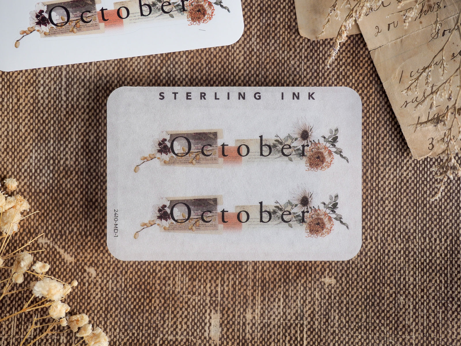 Elegant October monthly planner sticker featuring the word "October" framed by rustic, muted botanical and dried floral embellishments.