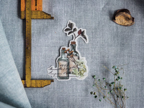 Autumnal die-cut sticker set featuring rustic glass bottles, delicate botanical illustrations, and vintage handwritten text for October 2023 planning.