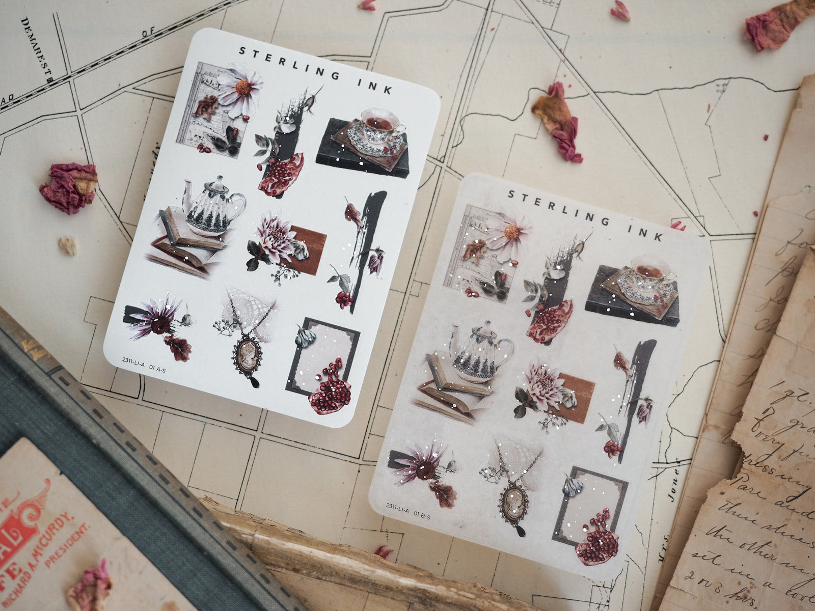 Decorative sticker sheets featuring autumnal icon sets, including dried botanicals, rustic teacups, and seasonal elements highlighted with silver foil accents.