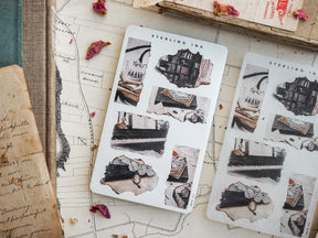 Sheets of decorative, black and white 'Sterling Ink' torn stickers, featuring vintage illustrations of borders, scrolls, and literary ephemera for journaling.