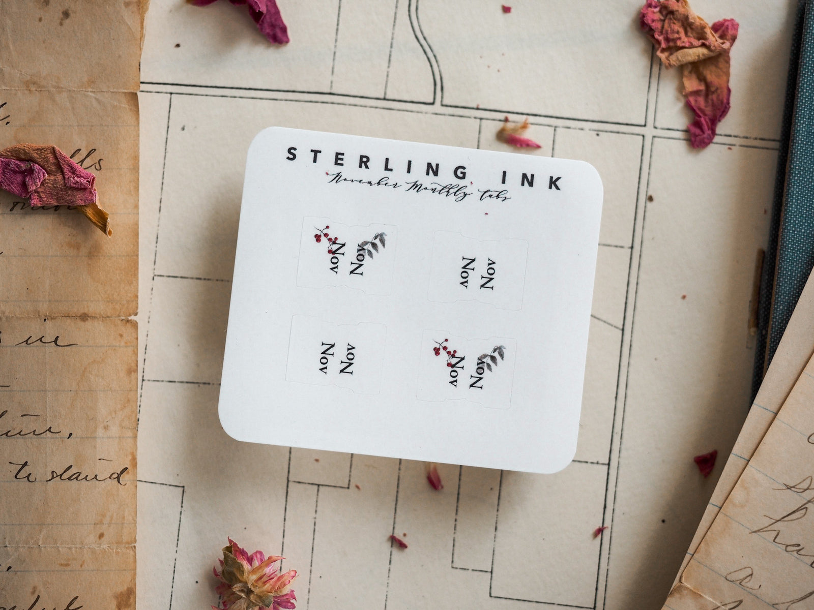 White, square monthly tab set for November, featuring elegant decorative autumnal leaf and berry motifs perfect for year-at-a-glance planning.