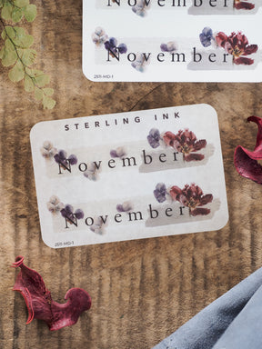 Elegant planner sticker labeling November, featuring a delicate watercolor design of dusty purple and muted autumn florals.