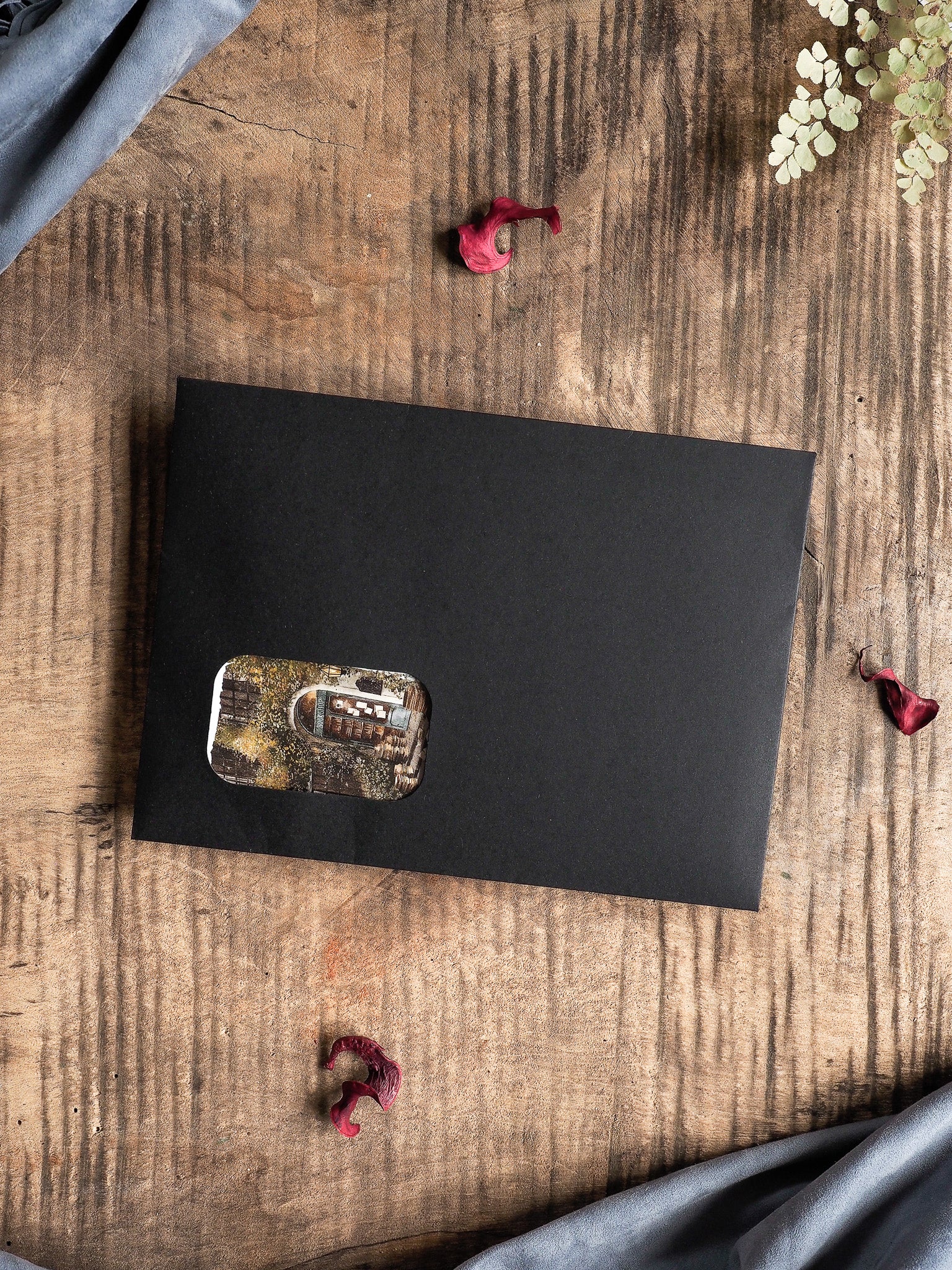 Matte black journaling sheet featuring a central, distressed sticker with a faded, rectangular, sepia-toned vintage design for decorative planning.