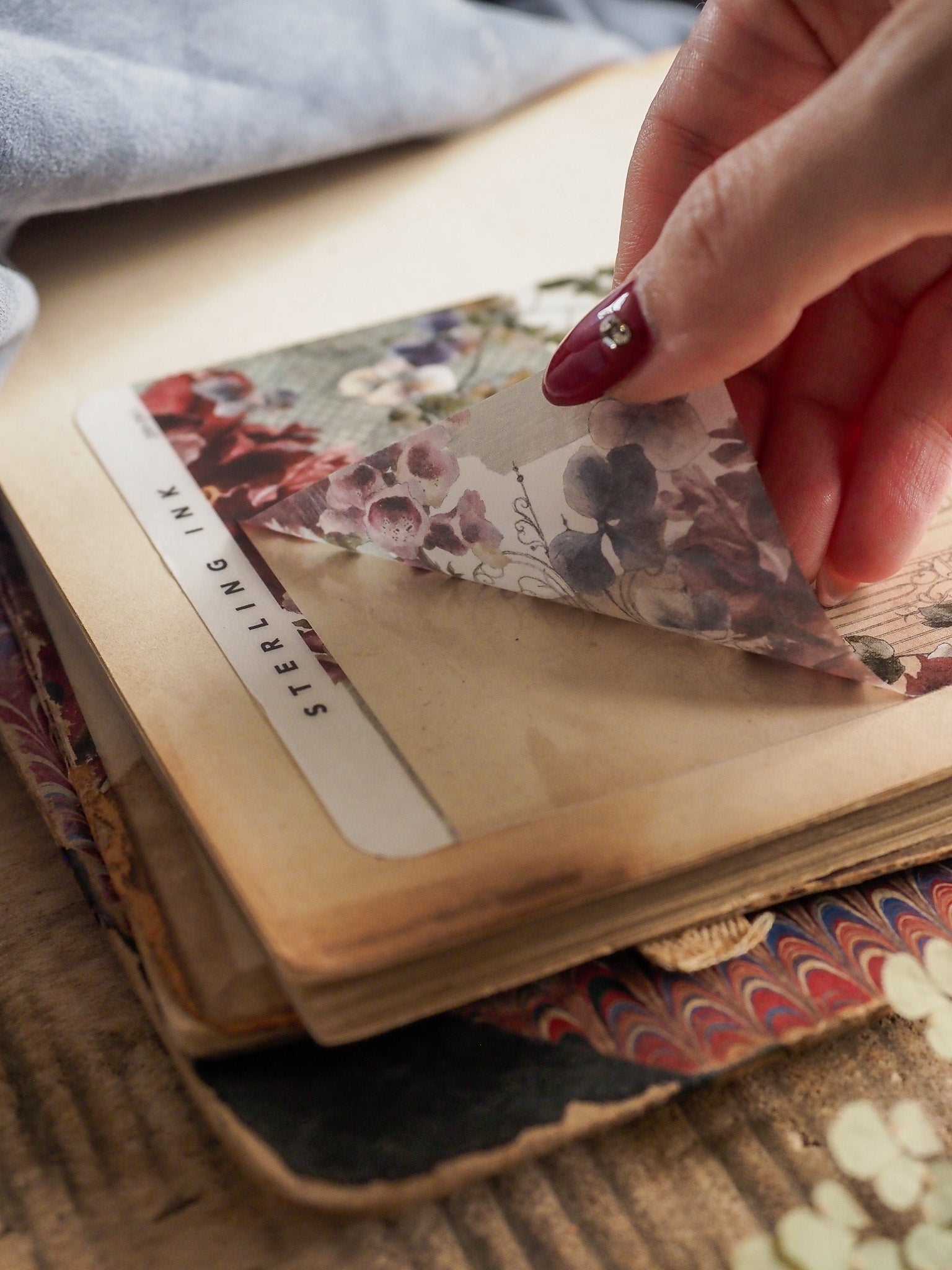 Vintage deco sheet featuring a lush, romantic floral pattern in deep purples, creams, and burgundy tones for decorating planners.