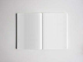 Open notebook displaying clean graph grid paper on both pages, providing structured space for organized notes, drafting, and mathematical sketching.