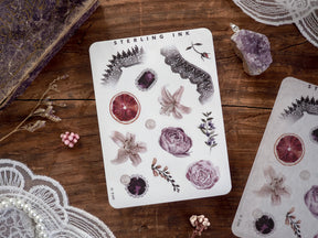 Elegant 'Elements Stickers - November 2024' sheet displaying various botanical motifs, including detailed illustrations of dried roses, sliced blood oranges, and assorted natural flora.
