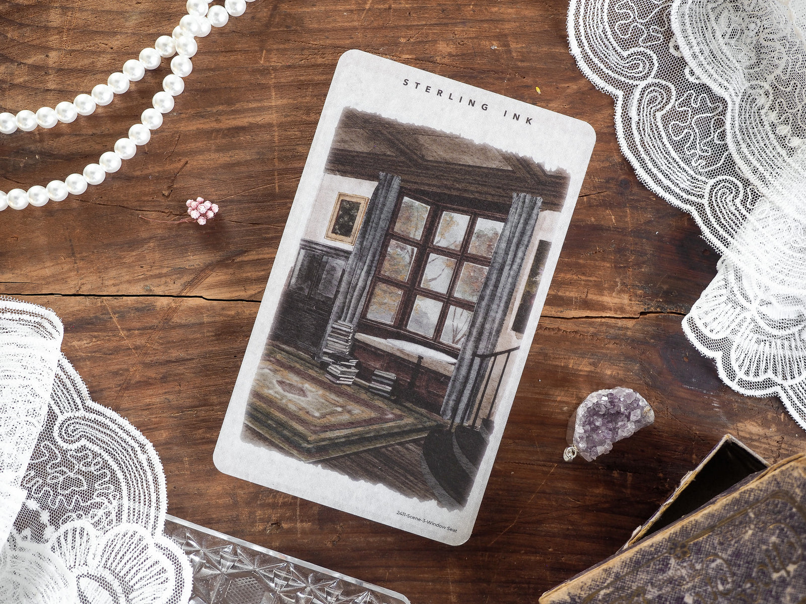 Vintage sticker featuring a detailed illustration of a cozy, autumnal window seat scene, branded with "Sterling Ink."