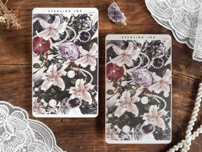 Elegant sticker sheets displaying a dramatic botanical pattern of creamy lilies and deep burgundy roses.