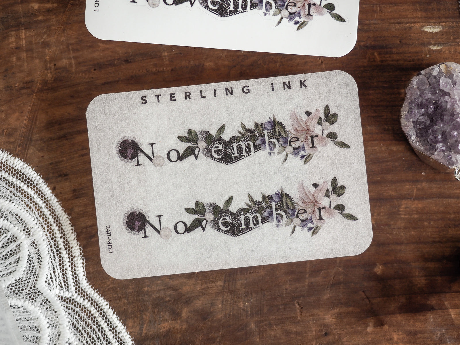 Elegant watercolor sticker for November, featuring delicate pink and green floral illustrations surrounding the printed month name.