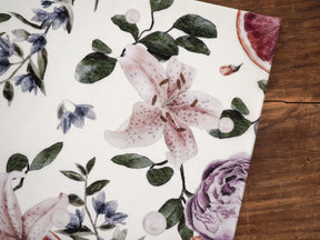 Botanical pattern with watercolor floral illustrations featuring lilies, roses, and deep green foliage on a cream background, titled 'Vellum - November 2024'.