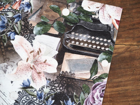 Botanical planner cover featuring 'Vellum - November 2024' with watercolor lilies, deep blue accents, green eucalyptus foliage, and vintage lace patterns.